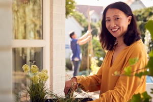 Adult woman cleaning outside home 